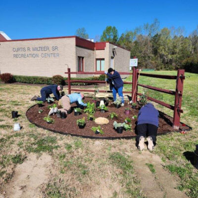 Volunteers planting new plants at Milteer Rec Center Garden